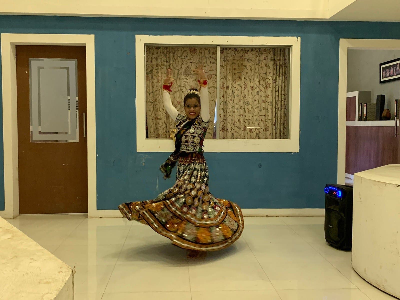 A dancer in a spinning mirrored skirt performing at the studio
