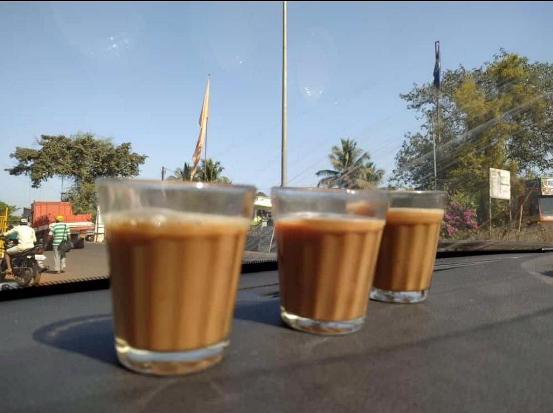 Three glasses of cutting chai on the bonnet of the car