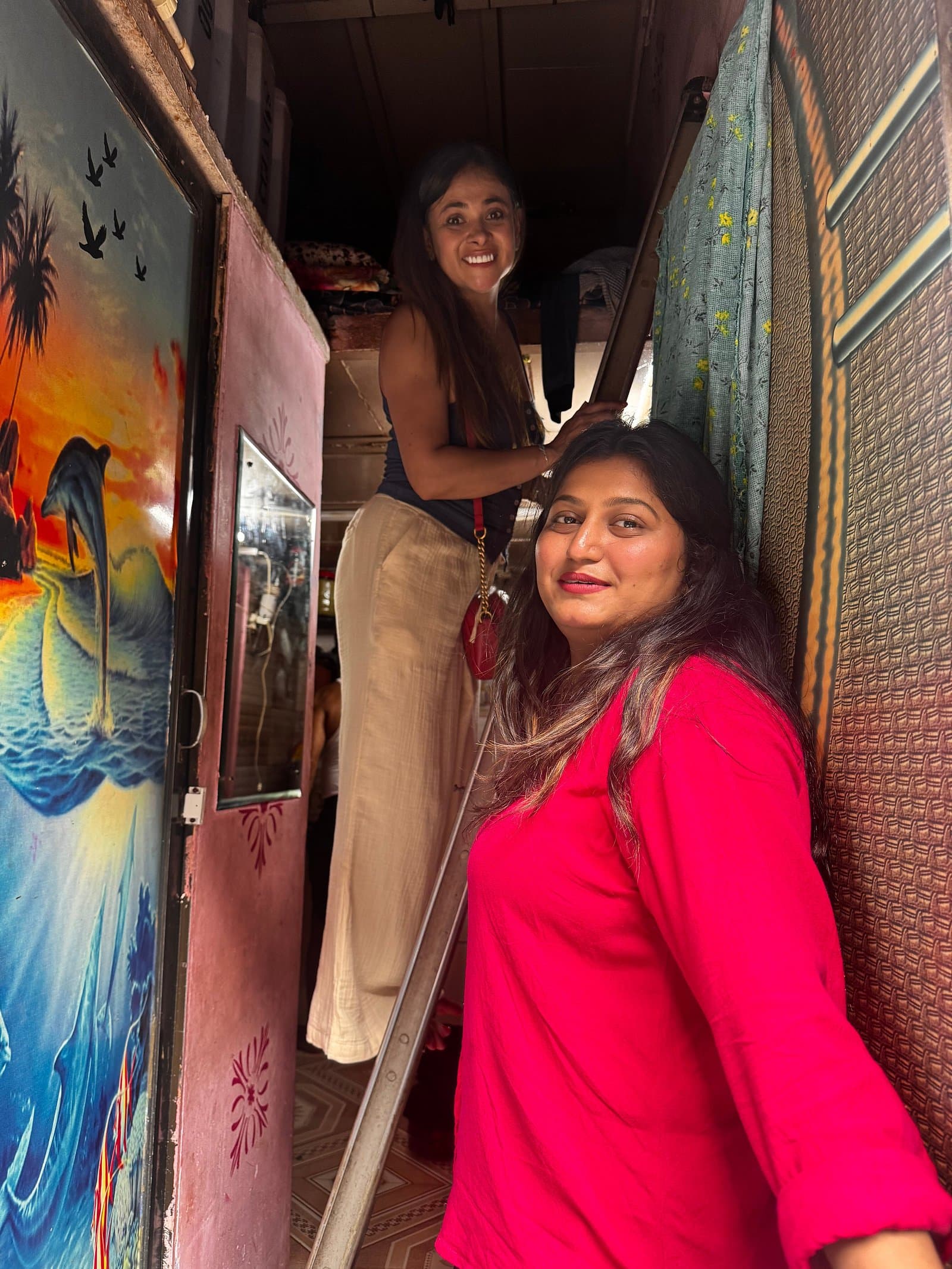Guests at a painted doorway in Dharavi
