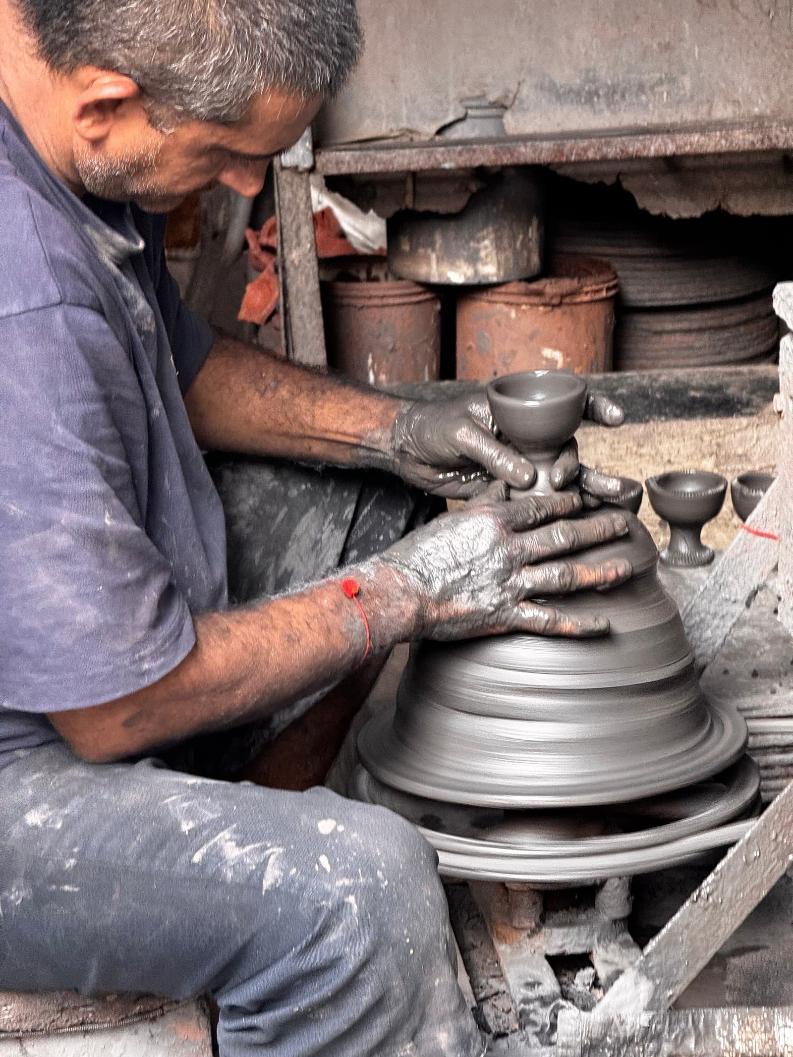 A potter at the wheel in Dharavi