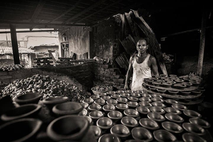 Rows of clay pots drying in a Dharavi pottery workshop
