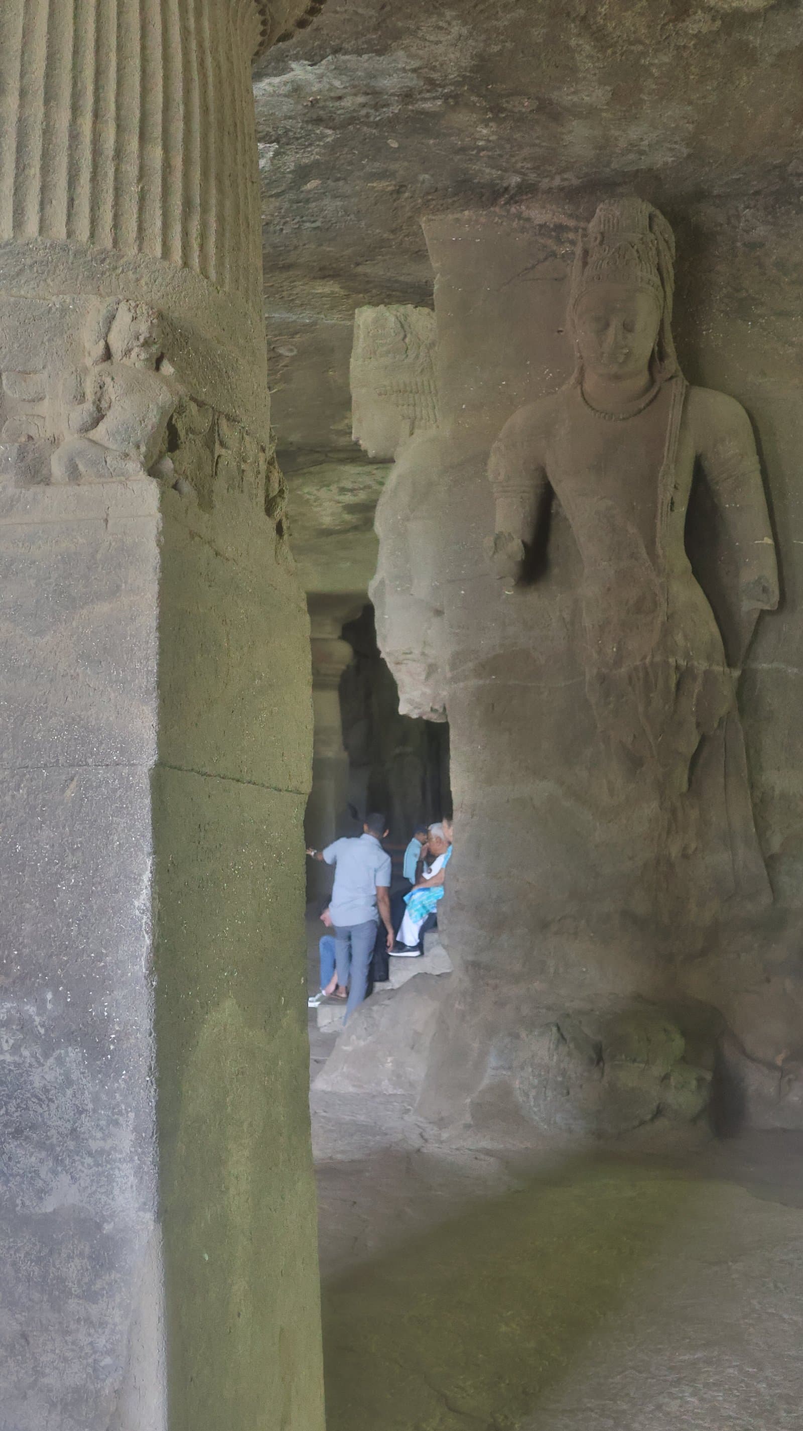 Guests resting beside a guardian figure in the main cave