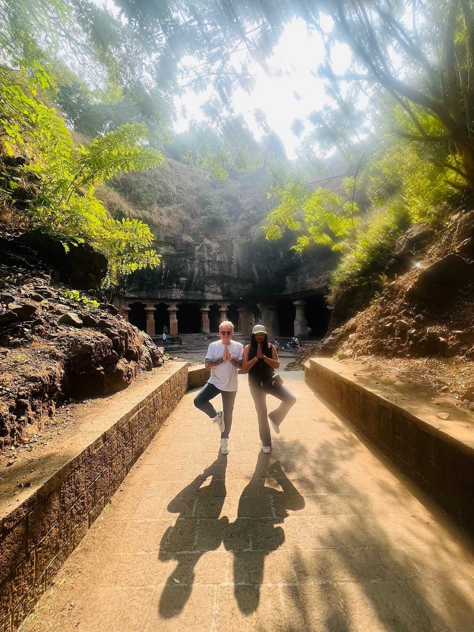 Guests striking a yoga pose at the entrance to the caves