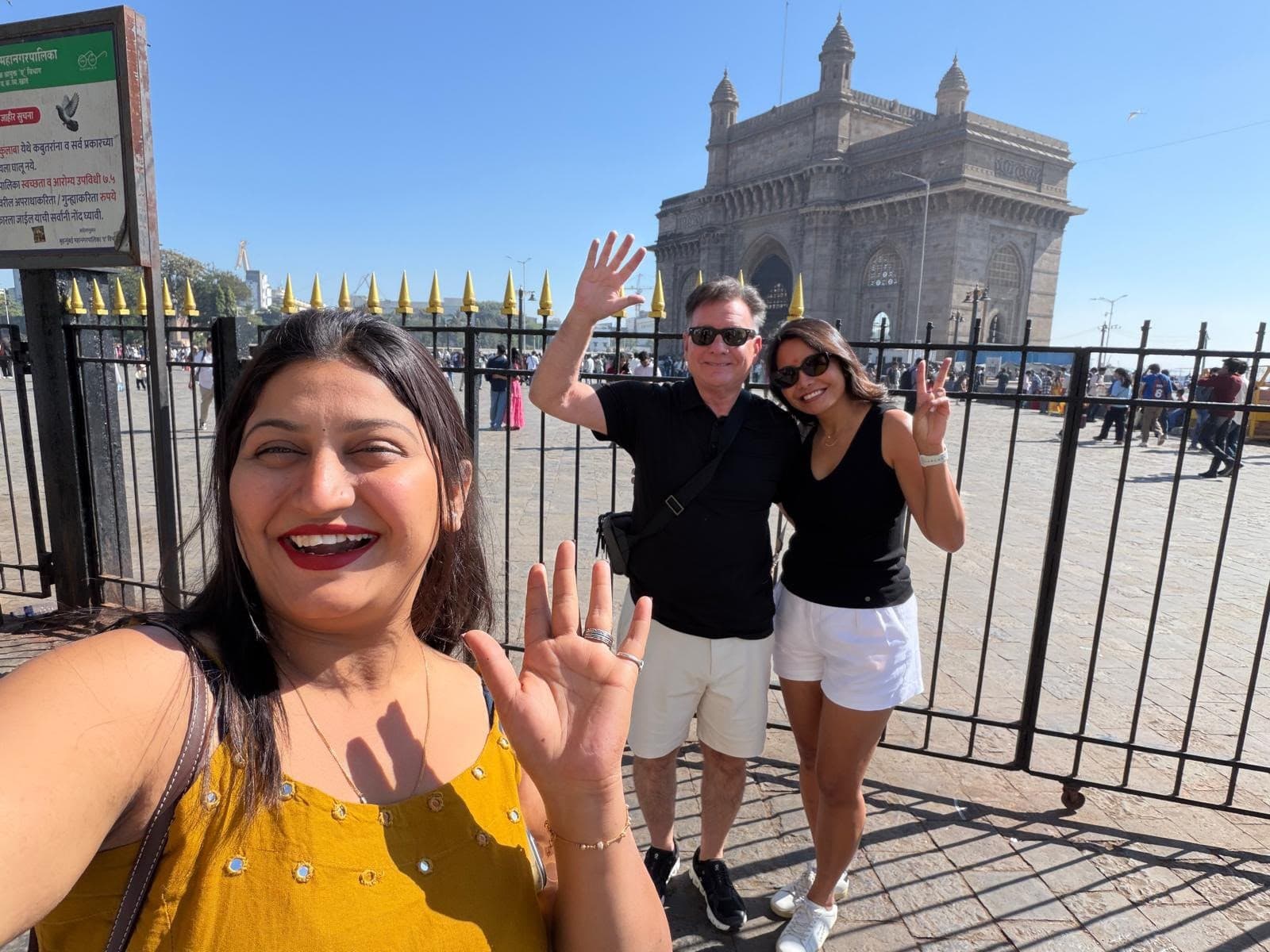 Guests taking a selfie in front of the Gateway of India