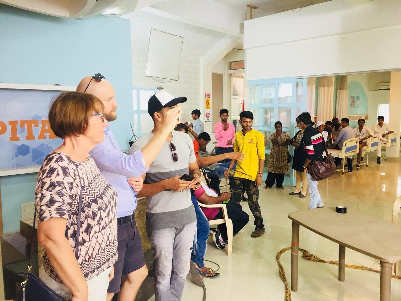 Guests watching a scene being set up on a hospital set