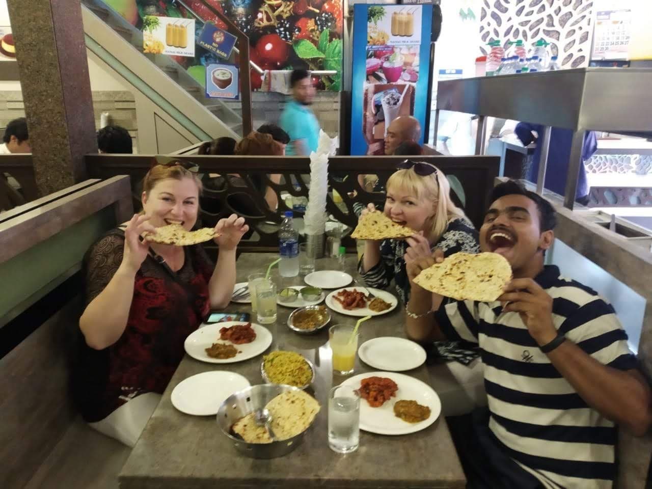 Guests enjoying a thali lunch at a local restaurant