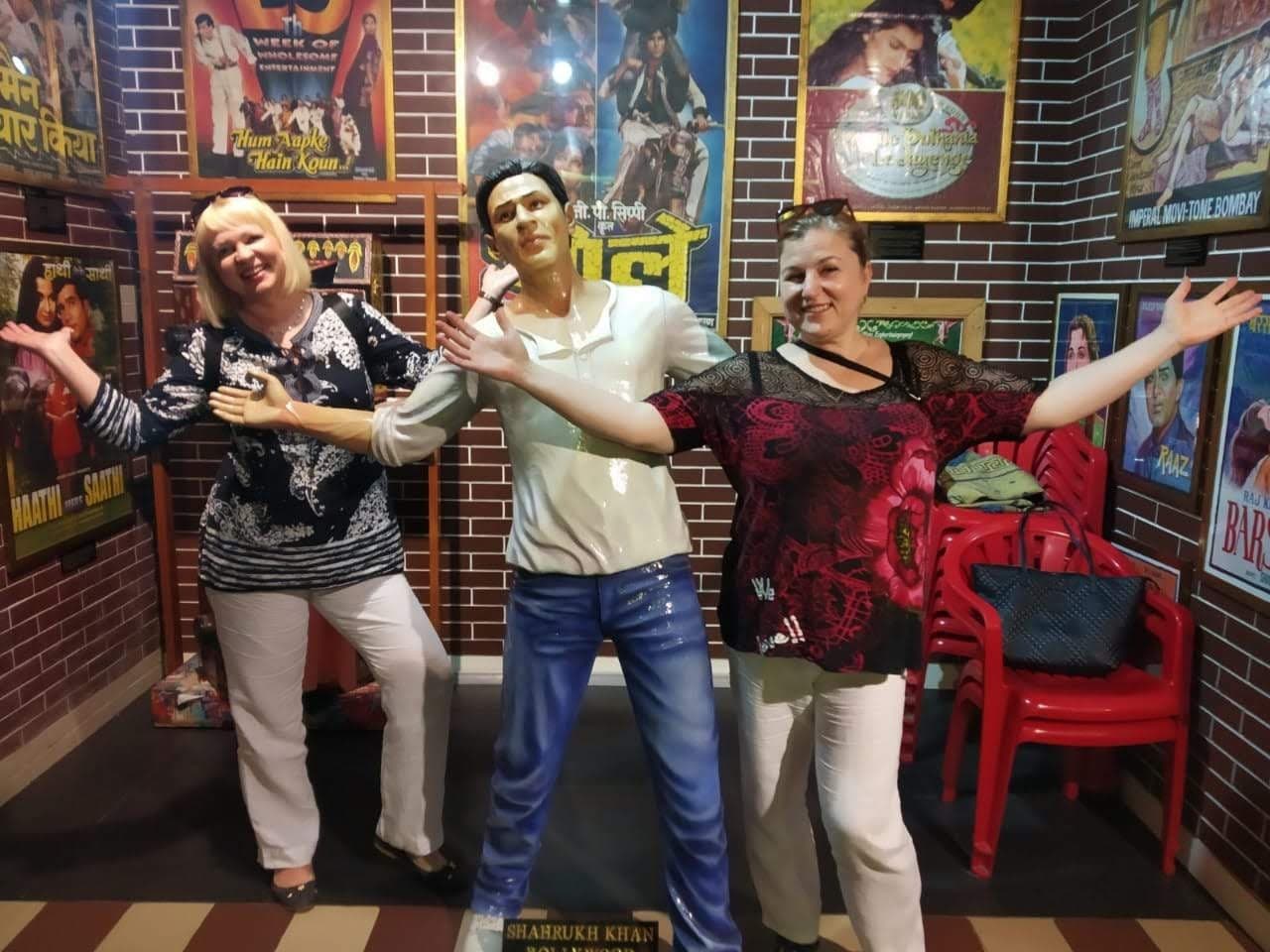 Guests posing in front of Bollywood film posters