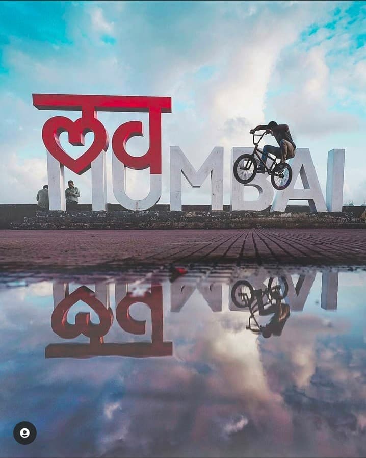 The Love Mumbai sign with a cyclist in silhouette