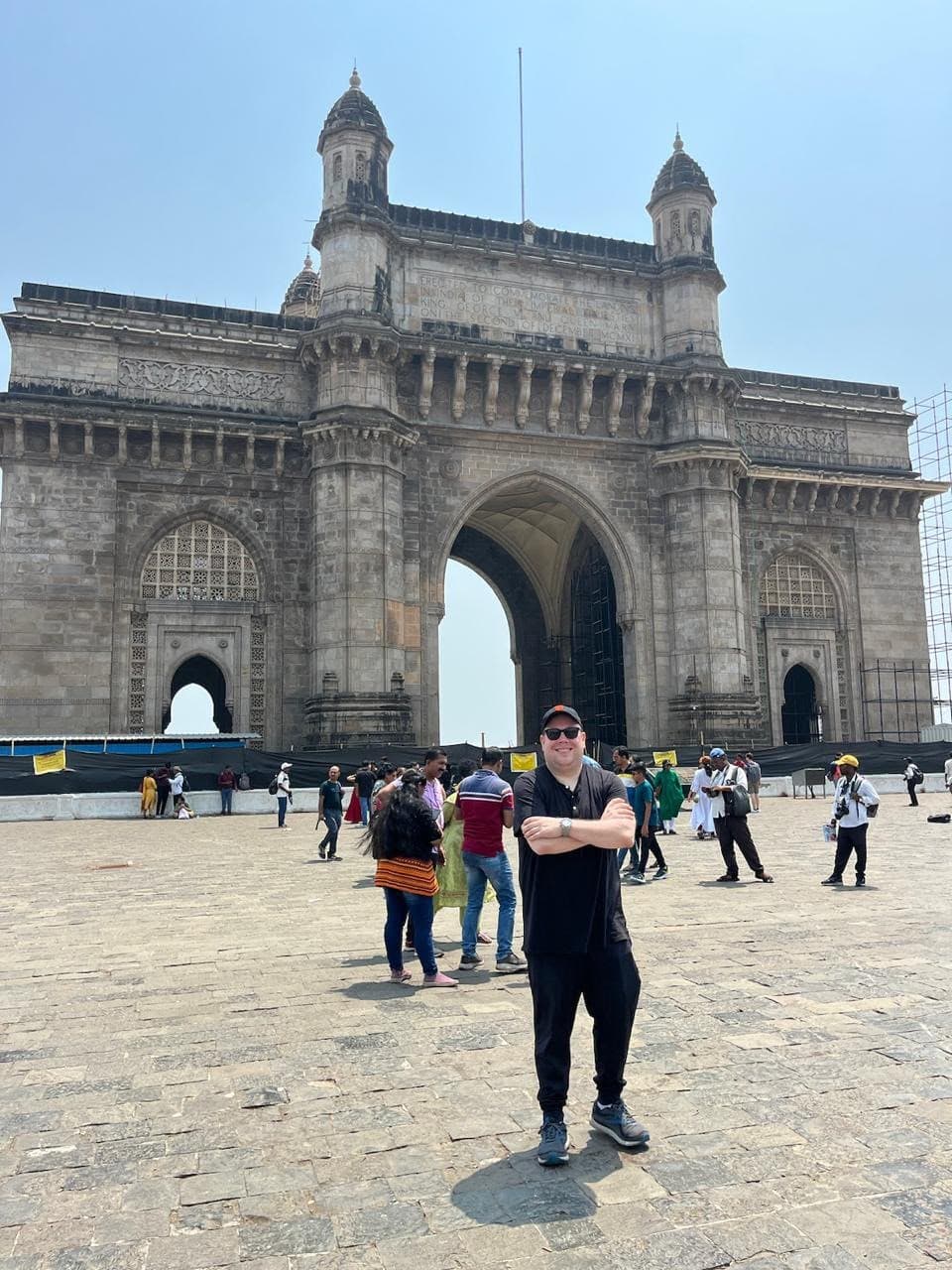A guest posing at the Gateway of India