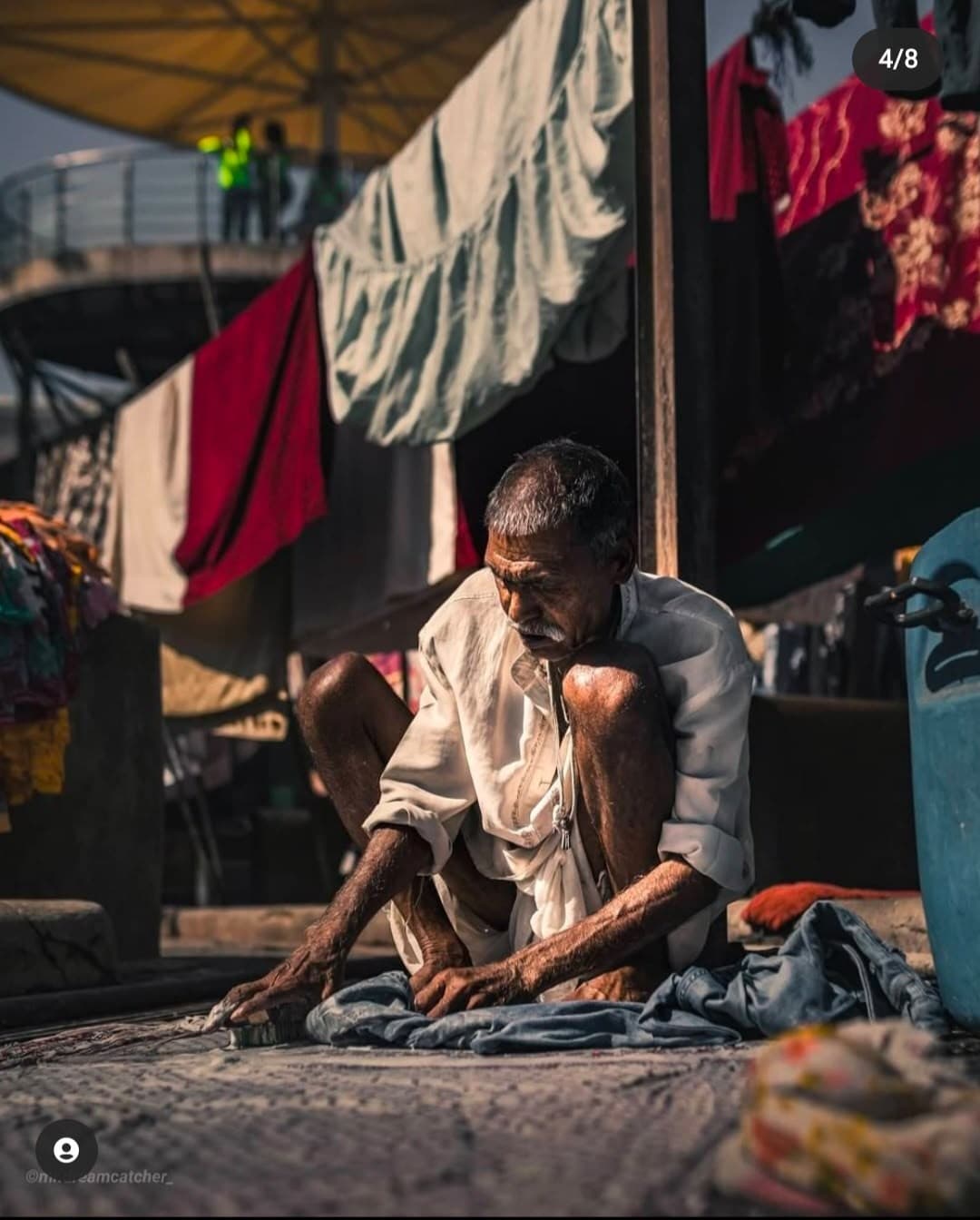 Washing lines and a dhobi at work at Dhobi Ghat